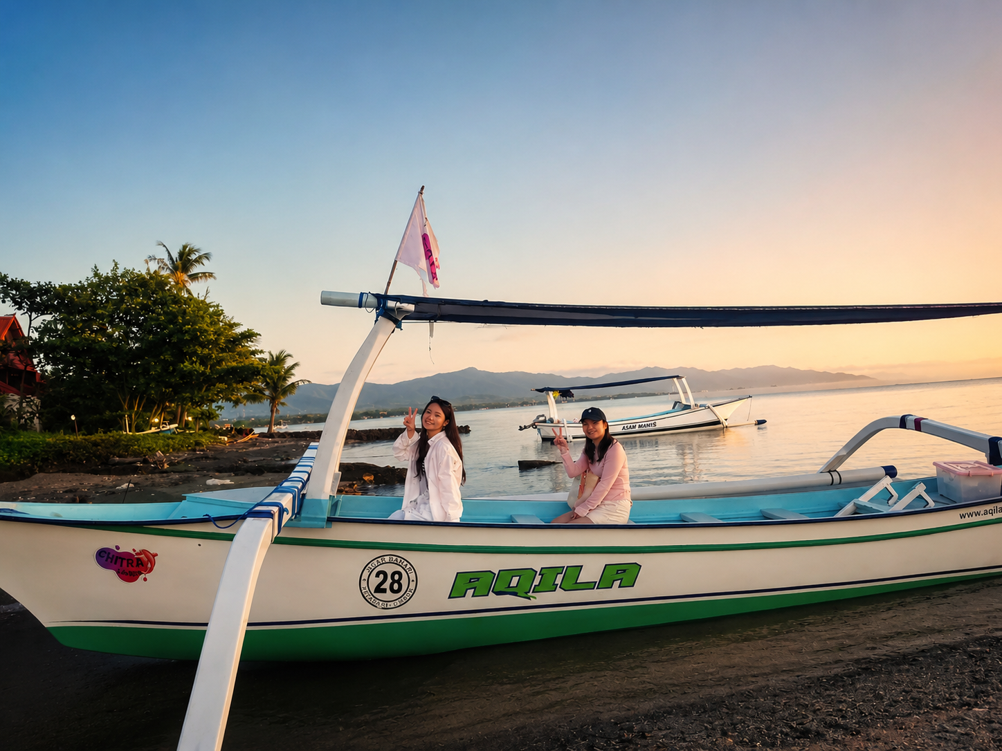Two guests on the traditional boat Aqila at the Lovina shoreline